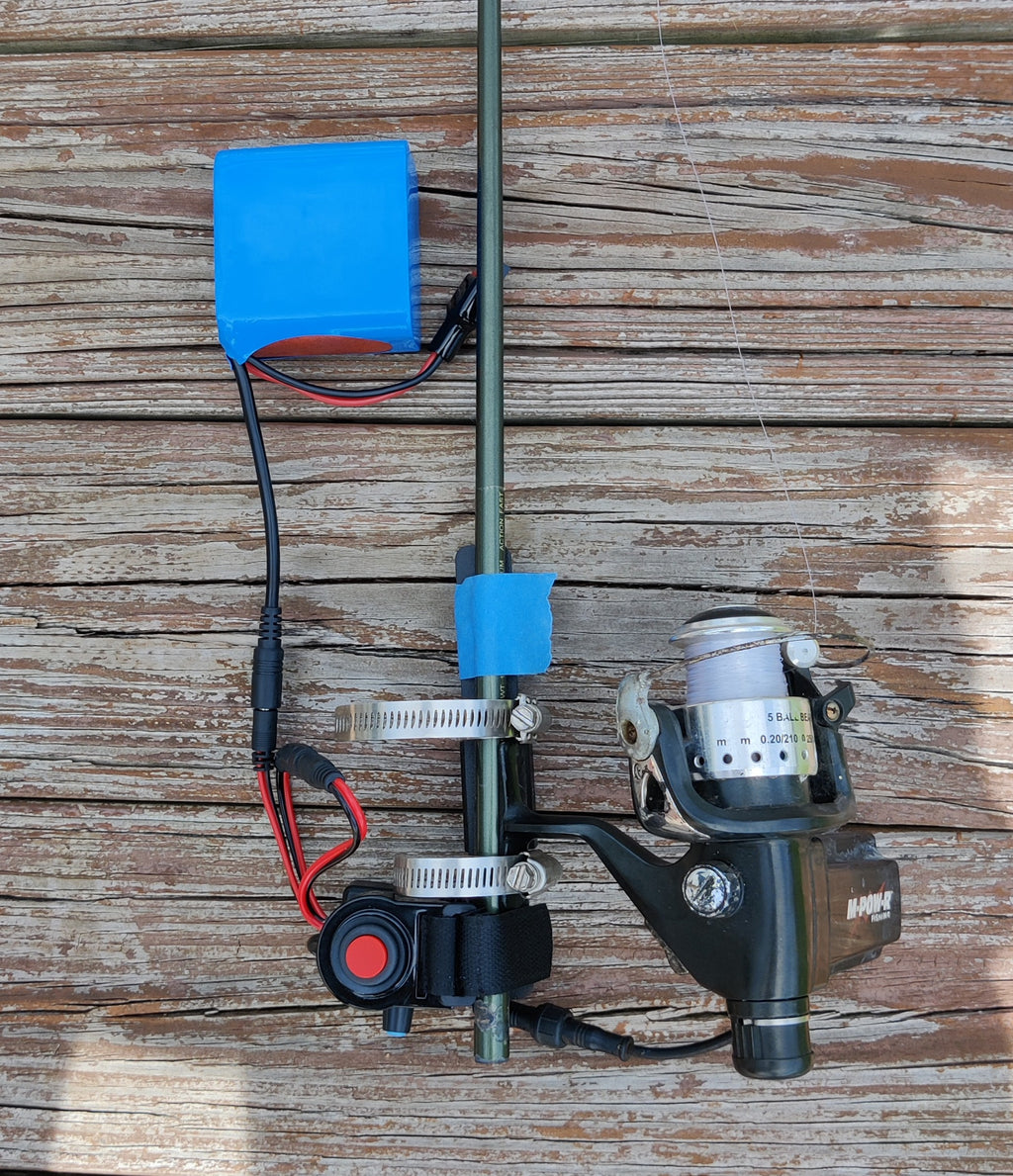 example of adaptive electric fishing reel on  shortened rod with handle removed to get close to  disabled wheelchair users belly